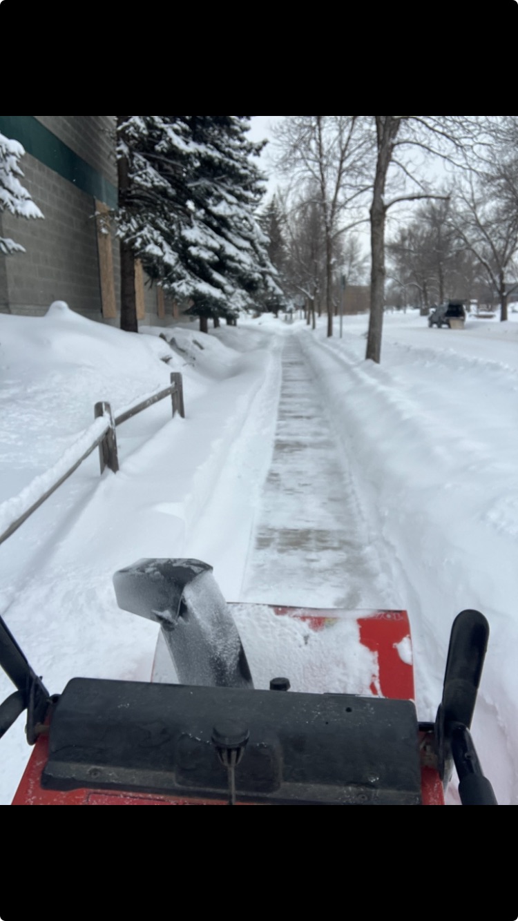 Commercial lot plowed at night in Bozeman